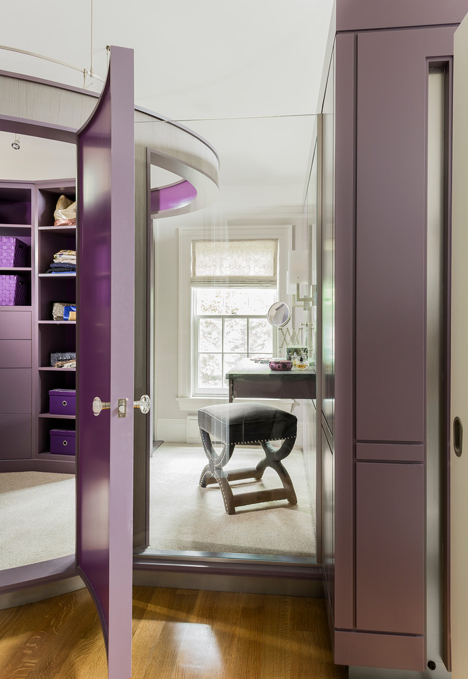 Design ideas for a large contemporary dressing room in Boston with medium hardwood floors.