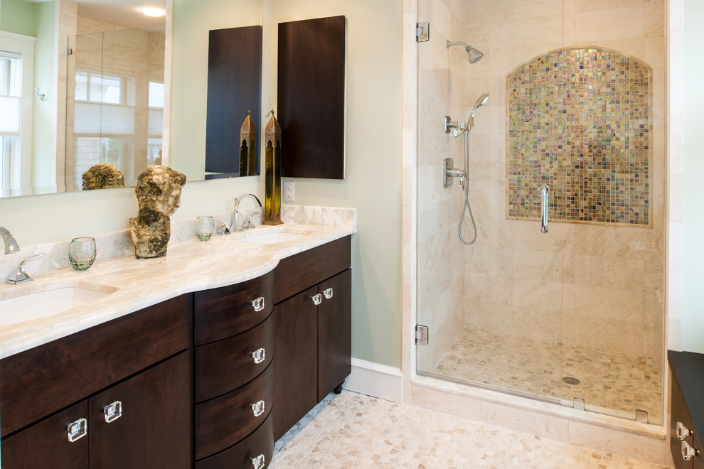 Mid-sized traditional master bathroom in New York with an undermount sink, flat-panel cabinets, dark wood cabinets, onyx benchtops, an alcove shower, a two-piece toilet, beige tile, ceramic tile, multi-coloured walls and ceramic floors.