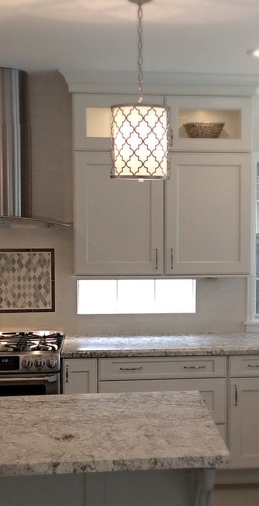 Inspiration for a mid-sized transitional u-shaped ceramic tile eat-in kitchen remodel in Houston with a farmhouse sink, recessed-panel cabinets, white cabinets, granite countertops, white backsplash, stone tile backsplash, stainless steel appliances and an island