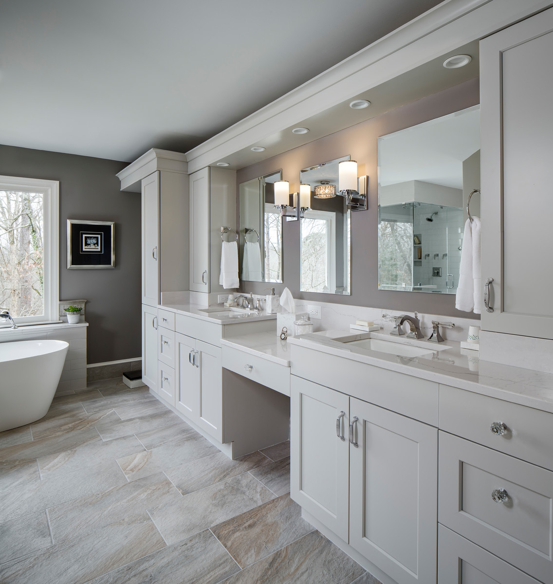 This is an example of a large transitional master bathroom in Atlanta with flat-panel cabinets, grey cabinets, a freestanding tub, a curbless shower, a two-piece toilet, gray tile, ceramic tile, grey walls, porcelain floors, an undermount sink, engineered quartz benchtops, grey floor and a hinged shower door.