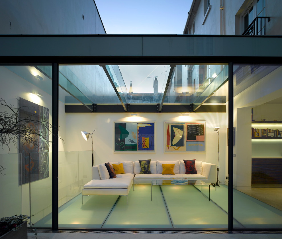 Photo of a contemporary sunroom in London with no fireplace and a glass ceiling.