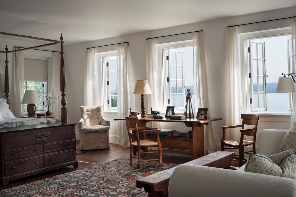 Design ideas for an expansive traditional master bedroom in New York with white walls and dark hardwood floors.