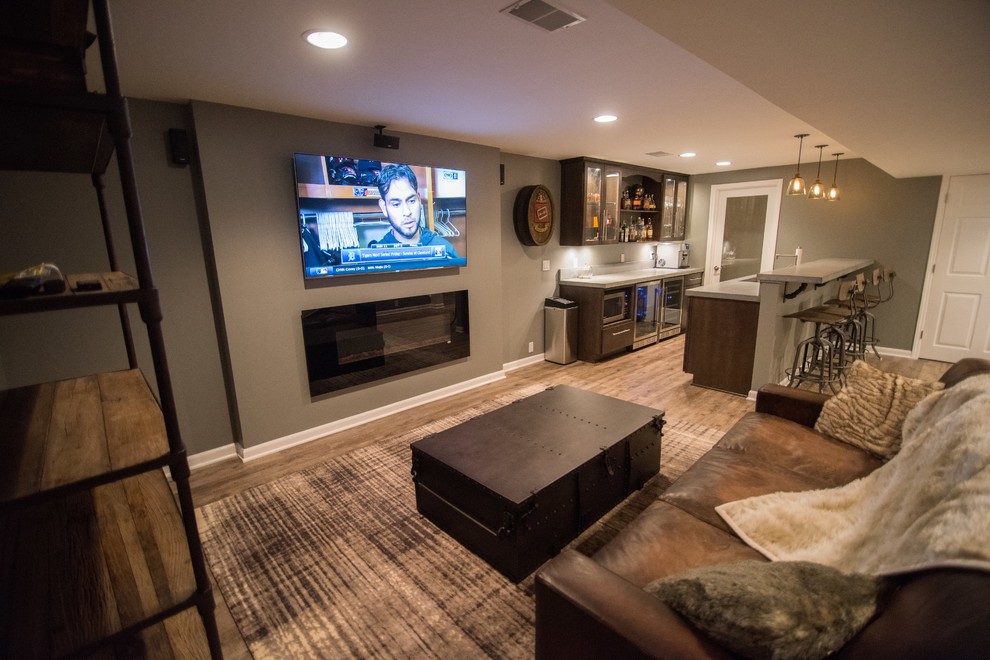 Mid-sized country fully buried basement in Detroit with grey walls, vinyl floors, brown floor and a ribbon fireplace.