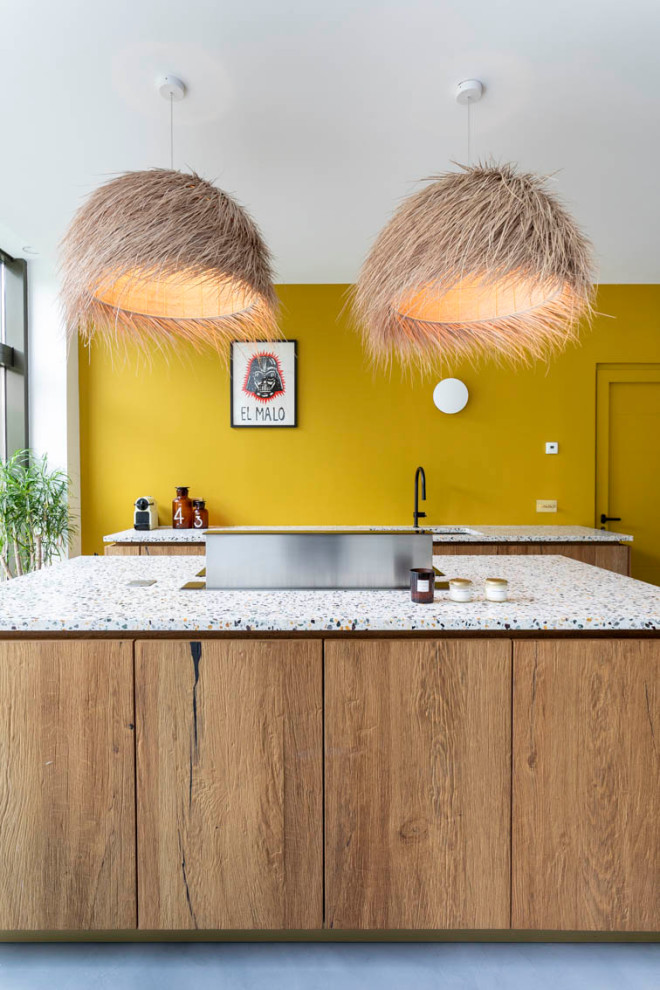 Design ideas for a large galley open plan kitchen in Paris with a submerged sink, beaded cabinets, dark wood cabinets, terrazzo worktops, yellow splashback, integrated appliances, concrete flooring, an island, grey floors and white worktops.