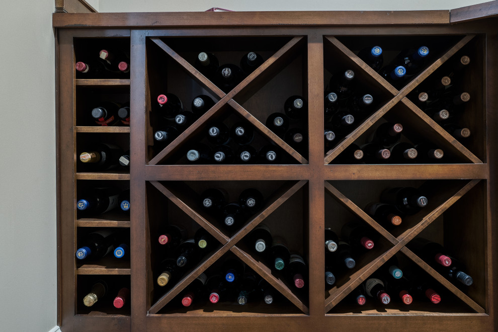 This is an example of an expansive traditional wine cellar in Cleveland with vinyl flooring and brown floors.