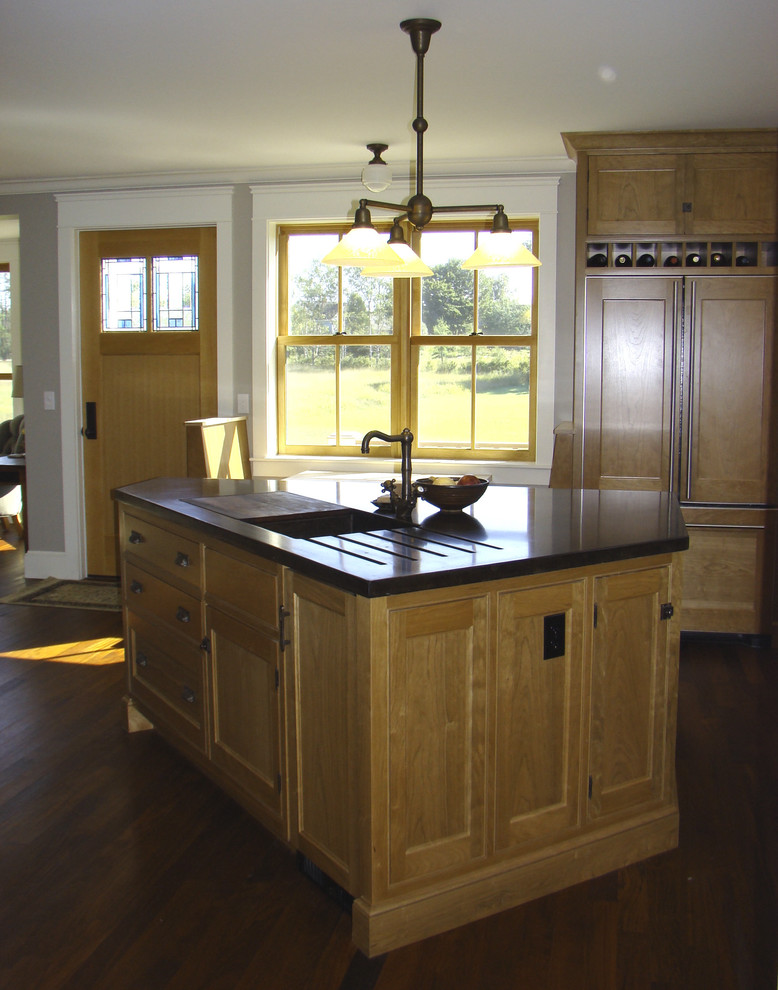 Design ideas for a mid-sized arts and crafts l-shaped open plan kitchen in Portland Maine with an integrated sink, beaded inset cabinets, medium wood cabinets, concrete benchtops, panelled appliances, dark hardwood floors and with island.