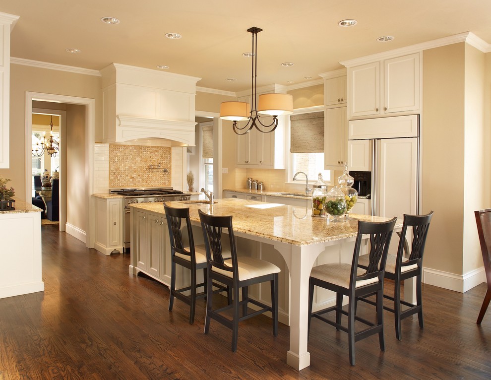 Eat-in kitchen - large transitional l-shaped medium tone wood floor eat-in kitchen idea in Dallas with an undermount sink, white cabinets, granite countertops, an island, recessed-panel cabinets, beige backsplash, mosaic tile backsplash and white appliances