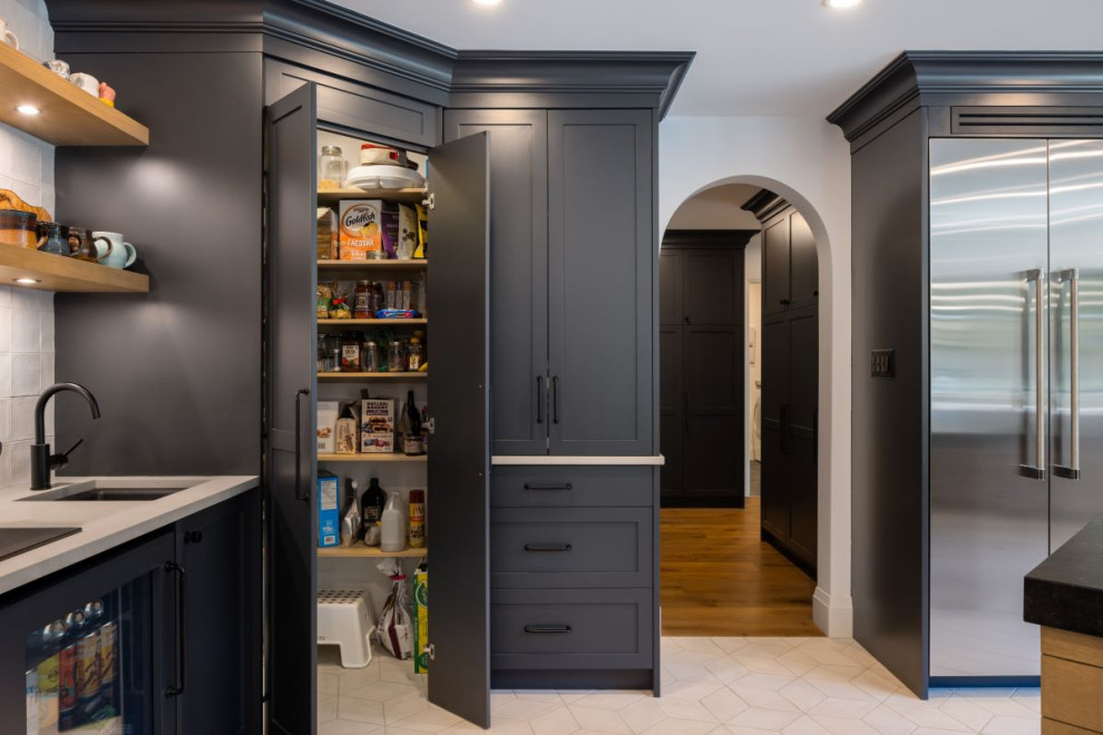 Inspiration for a mid-sized transitional u-shaped porcelain tile and white floor kitchen pantry remodel in Vancouver with an undermount sink, shaker cabinets, gray cabinets, granite countertops, white backsplash, porcelain backsplash, stainless steel appliances, a peninsula and black countertops