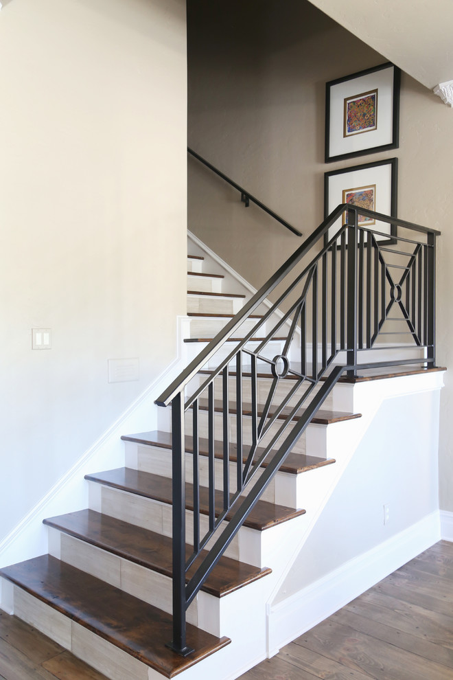 Design ideas for a mid-sized transitional wood l-shaped staircase in Other with painted wood risers and metal railing.