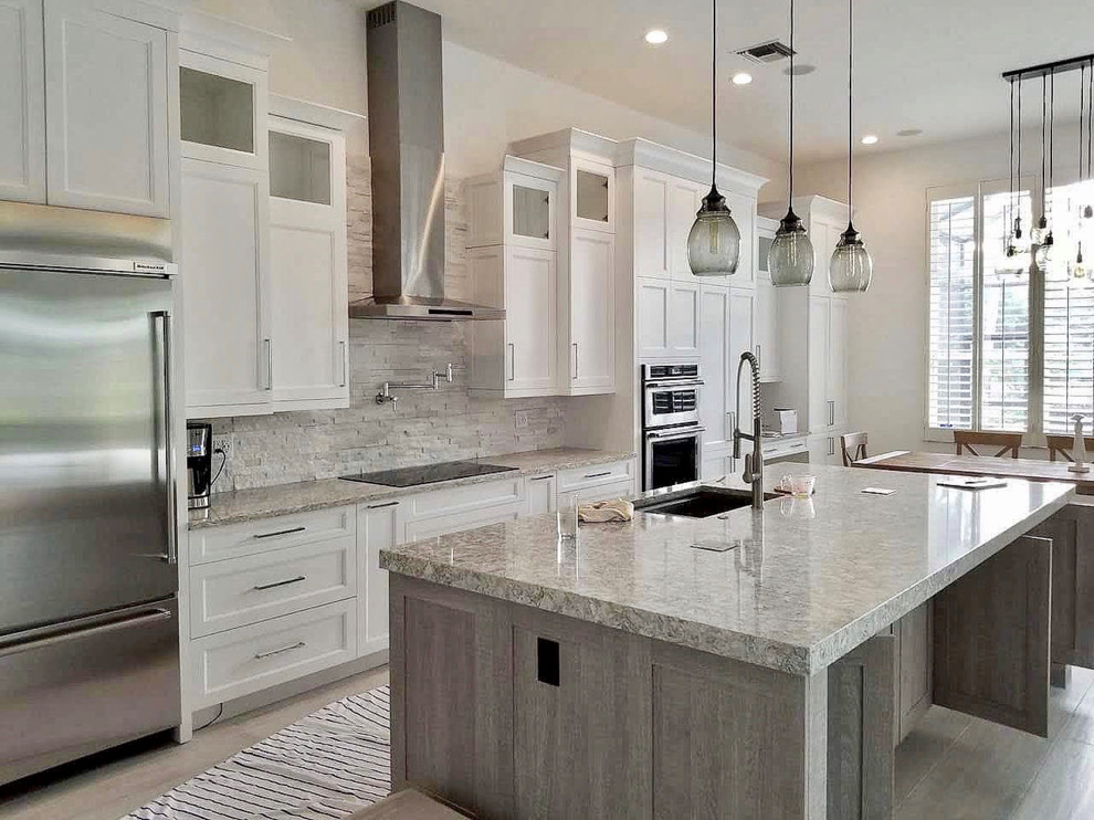 Example of a transitional eat-in kitchen design in Miami with shaker cabinets, white cabinets and an island