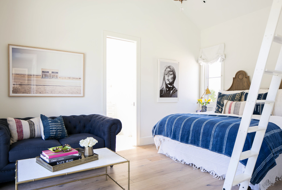 Photo of a modern guest bedroom in Phoenix with white walls, light hardwood floors and white floor.