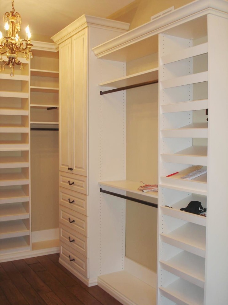 Photo of a large traditional women's walk-in wardrobe in Chicago with raised-panel cabinets, white cabinets and medium hardwood floors.