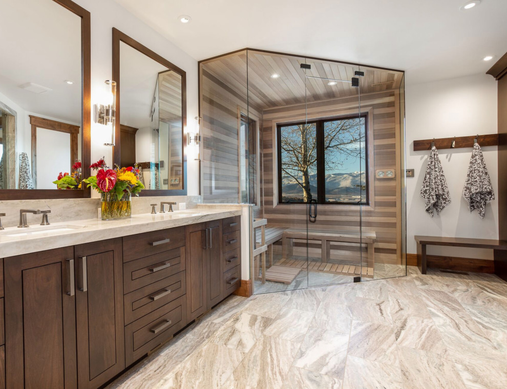 Inspiration for a large transitional bathroom in Salt Lake City with raised-panel cabinets, dark wood cabinets, an alcove shower, white walls, limestone floors, with a sauna, an undermount sink, granite benchtops, beige floor, a hinged shower door, beige benchtops, a shower seat, a double vanity and a built-in vanity.
