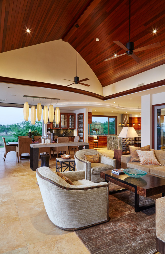 Photo of an expansive tropical open concept living room in Hawaii with multi-coloured walls and travertine floors.