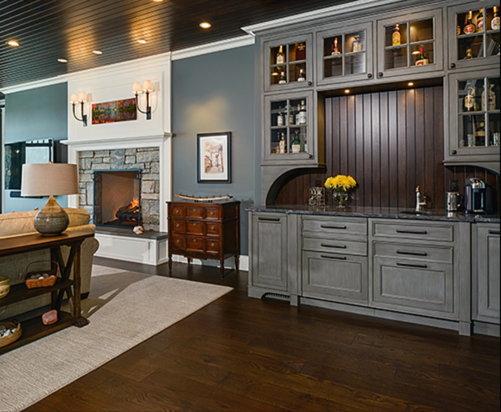 Inspiration for a large transitional walk-out dark wood floor and brown floor basement remodel with blue walls, a standard fireplace and a stone fireplace