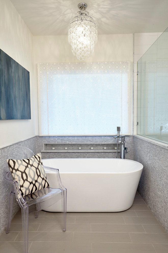 Design ideas for a contemporary master bathroom in Austin with a freestanding tub, gray tile and white walls.