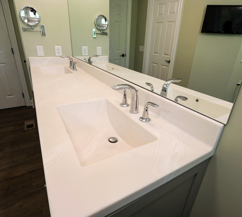 Mid-sized transitional master white tile laminate floor, blue floor and double-sink bathroom photo in Cleveland with flat-panel cabinets, gray cabinets, a two-piece toilet, green walls, an integrated sink, solid surface countertops, beige countertops and a freestanding vanity