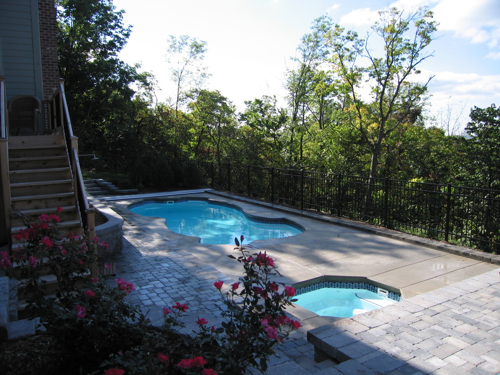 Inspiration for a mid-sized mediterranean backyard concrete paver and custom-shaped pool remodel