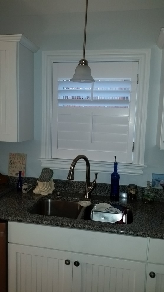 Example of a transitional kitchen design with beaded inset cabinets, white cabinets and granite countertops