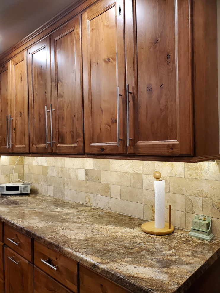 Kitchen - small transitional porcelain tile and beige floor kitchen idea with an undermount sink, recessed-panel cabinets, brown cabinets, laminate countertops, beige backsplash, porcelain backsplash, stainless steel appliances, no island and brown countertops