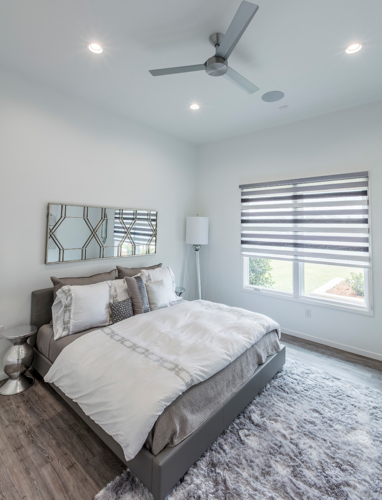 Mid-sized transitional guest vinyl floor bedroom photo with white walls