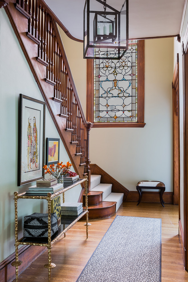 This is an example of a mid-sized traditional wood l-shaped staircase in Boston with wood risers and wood railing.