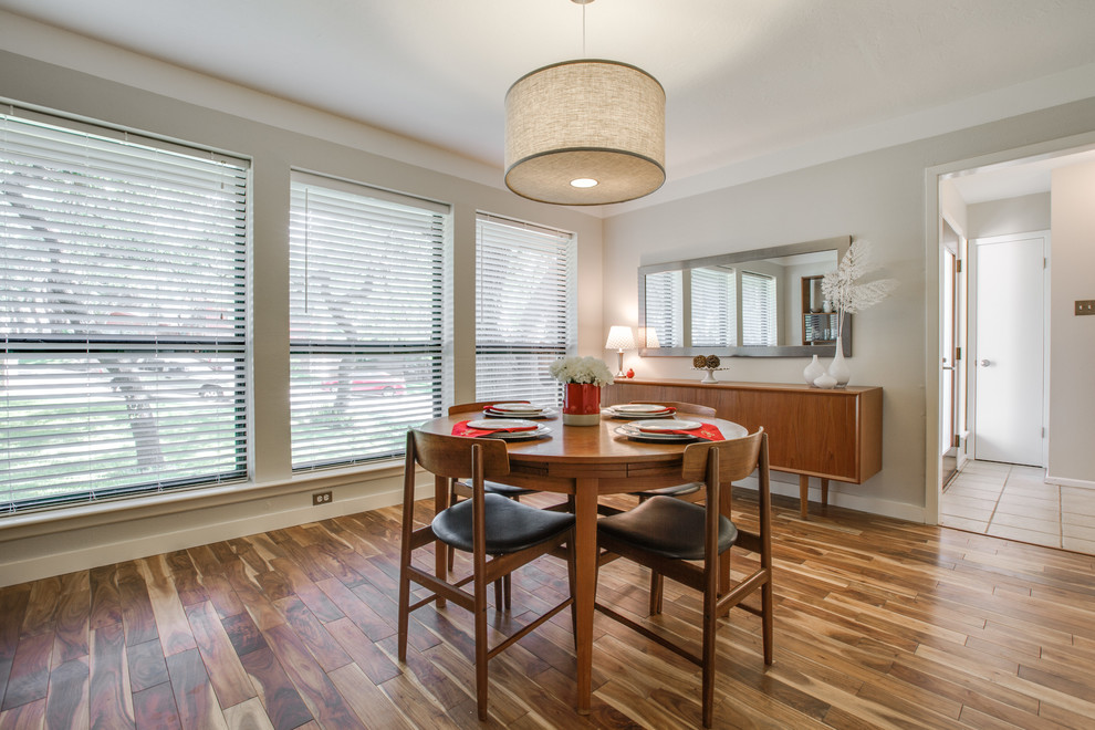 This is an example of a mid-sized contemporary separate dining room in Austin with beige walls and light hardwood floors.