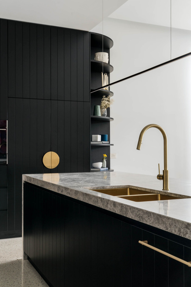 Large contemporary l-shaped open plan kitchen in Melbourne with a double-bowl sink, black cabinets, marble benchtops, grey splashback, marble splashback, black appliances, concrete floors, with island, grey floor and grey benchtop.