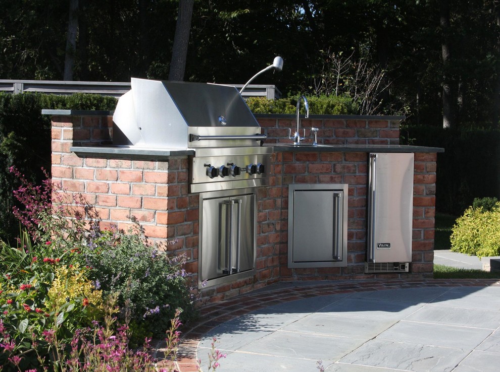 Mid-sized traditional backyard patio in New York with an outdoor kitchen, concrete pavers and no cover.