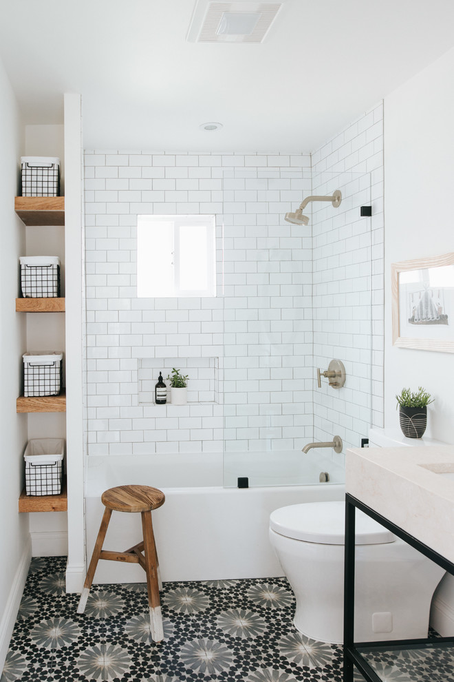 Mid-sized contemporary kids bathroom in Other with open cabinets, an alcove tub, a shower/bathtub combo, a two-piece toilet, white tile, porcelain tile, white walls, cement tiles, marble benchtops, multi-coloured floor, an open shower, beige benchtops, an undermount sink and a niche.