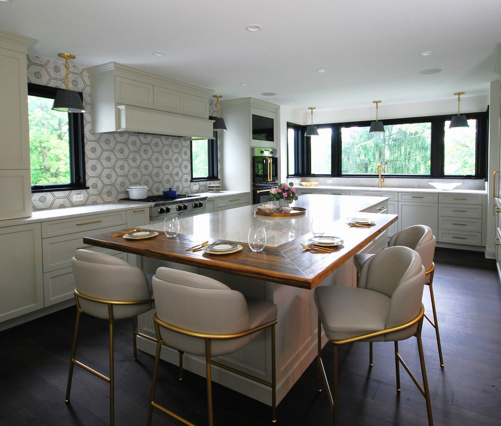 Open concept kitchen - large transitional l-shaped dark wood floor and brown floor open concept kitchen idea in Philadelphia with an undermount sink, shaker cabinets, beige cabinets, quartzite countertops, beige backsplash, porcelain backsplash, black appliances, an island and beige countertops