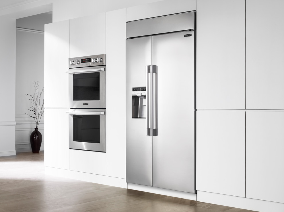 Inspiration for a large contemporary galley medium tone wood floor and brown floor open concept kitchen remodel in New York with an undermount sink, flat-panel cabinets, white cabinets, quartzite countertops, multicolored backsplash, stone slab backsplash, stainless steel appliances and an island