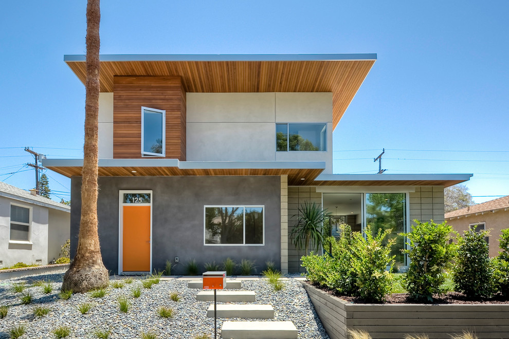 Inspiration for a midcentury two-storey exterior in San Diego with mixed siding.