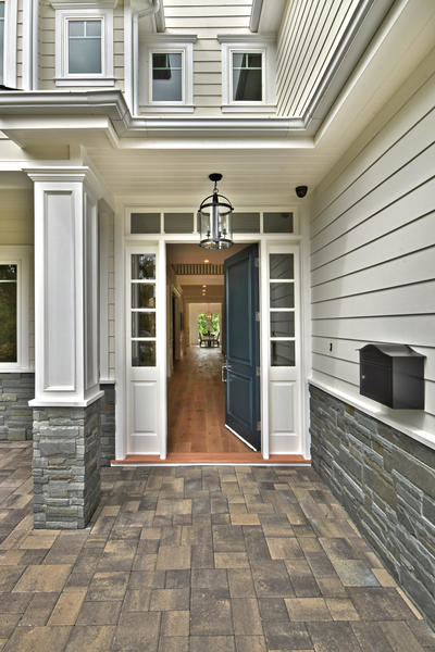 Inspiration for a mid-sized transitional medium tone wood floor single front door remodel with gray walls