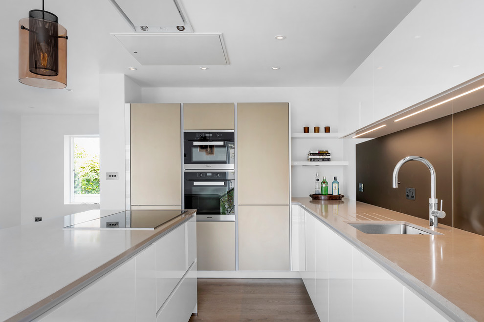 Design ideas for a large contemporary u-shaped open plan kitchen in Other with a drop-in sink.