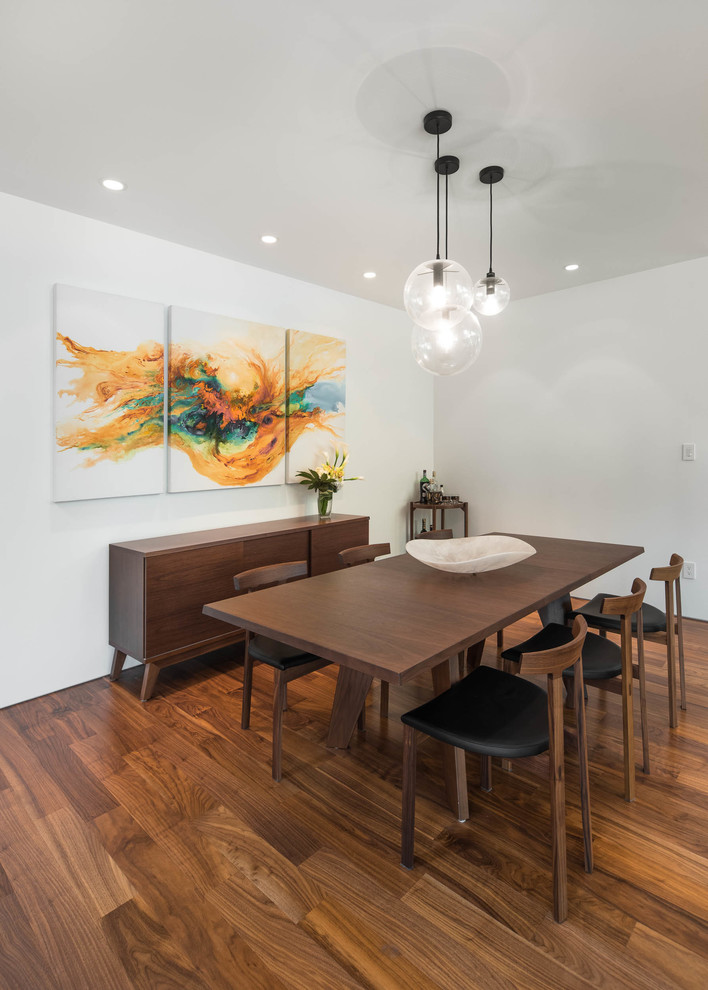 Inspiration for a mid-sized 1960s medium tone wood floor and brown floor great room remodel in Vancouver with white walls and no fireplace