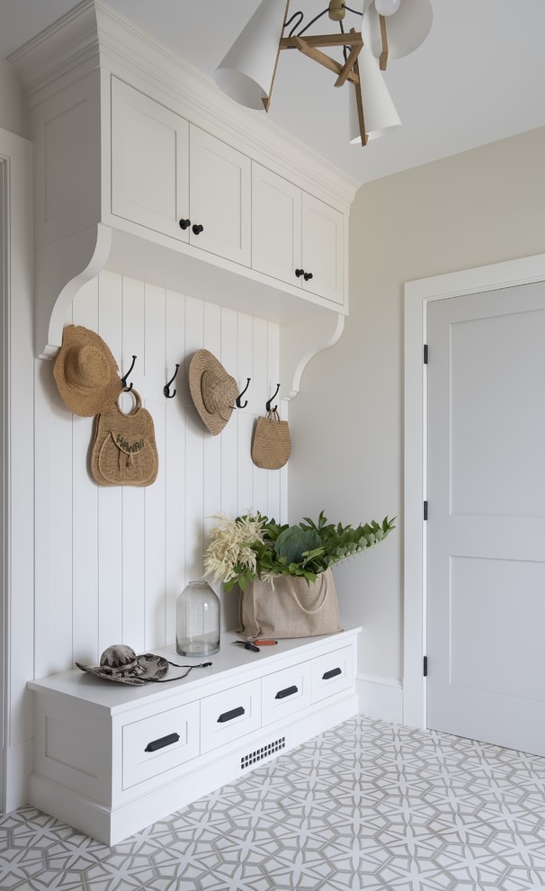 Inspiration for a transitional mudroom in Portland Maine with white walls and white floor.