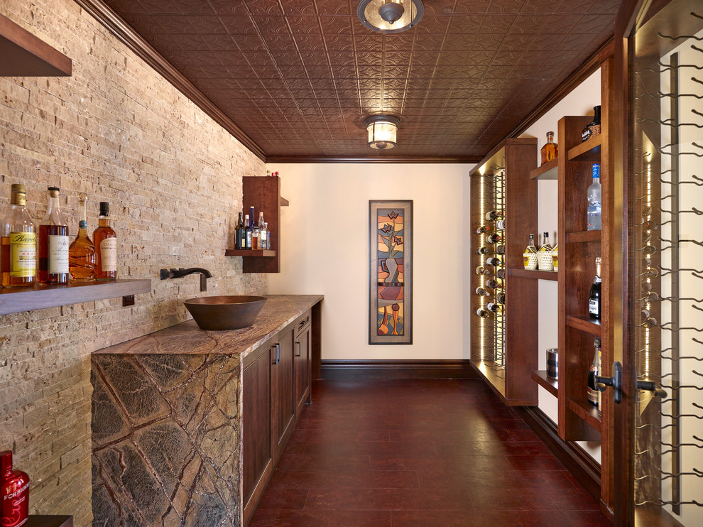 Photo of a transitional wine cellar in Edmonton with display racks and red floor.