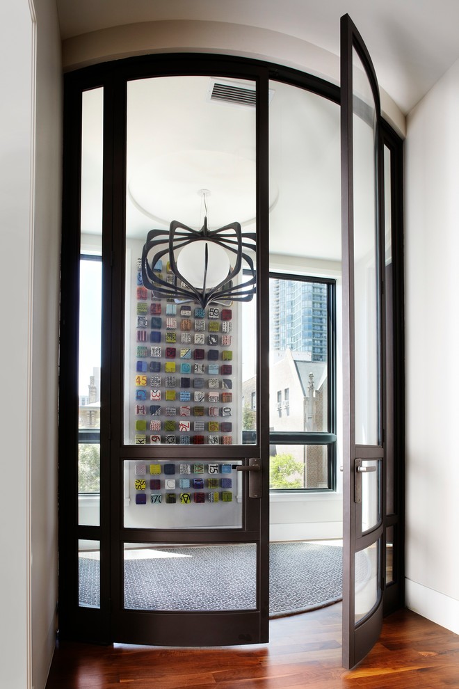 Photo of a contemporary entryway in Chicago with a double front door and a glass front door.