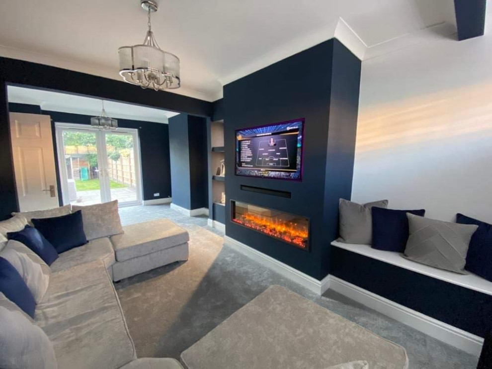 This is an example of a modern living room in Manchester with blue walls, carpet, no fireplace, a built-in media wall and grey floor.