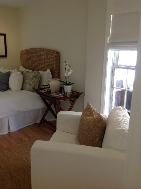 Medium tone wood floor bedroom photo in San Francisco with white walls