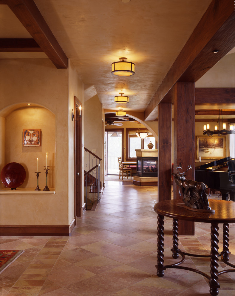 Design ideas for a traditional hallway in Denver with beige walls and travertine floors.