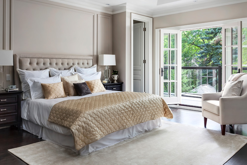 Inspiration for a traditional master bedroom in Toronto with beige walls, dark hardwood floors and brown floor.