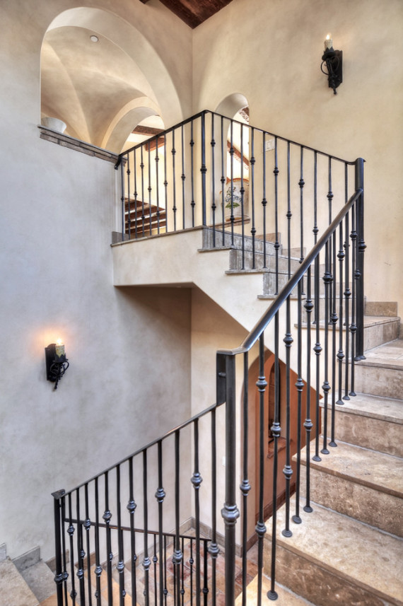 Inspiration for a mid-sized mediterranean tile u-shaped staircase in Los Angeles with tile risers and metal railing.