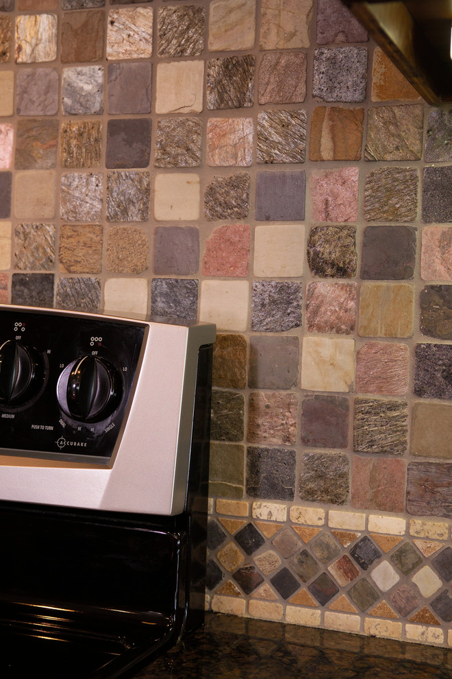 Example of a large transitional u-shaped porcelain tile home design design with an undermount sink, recessed-panel cabinets, dark wood cabinets, granite countertops, gray backsplash, ceramic backsplash, stainless steel appliances and two islands