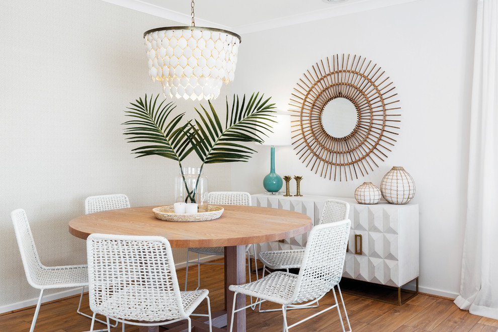 Design ideas for a beach style dining room in Melbourne with white walls, medium hardwood floors and brown floor.