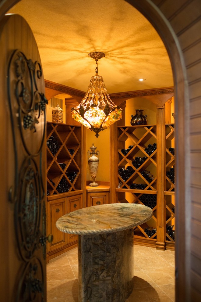 Mid-sized mediterranean wine cellar in Toronto with limestone floors and display racks.