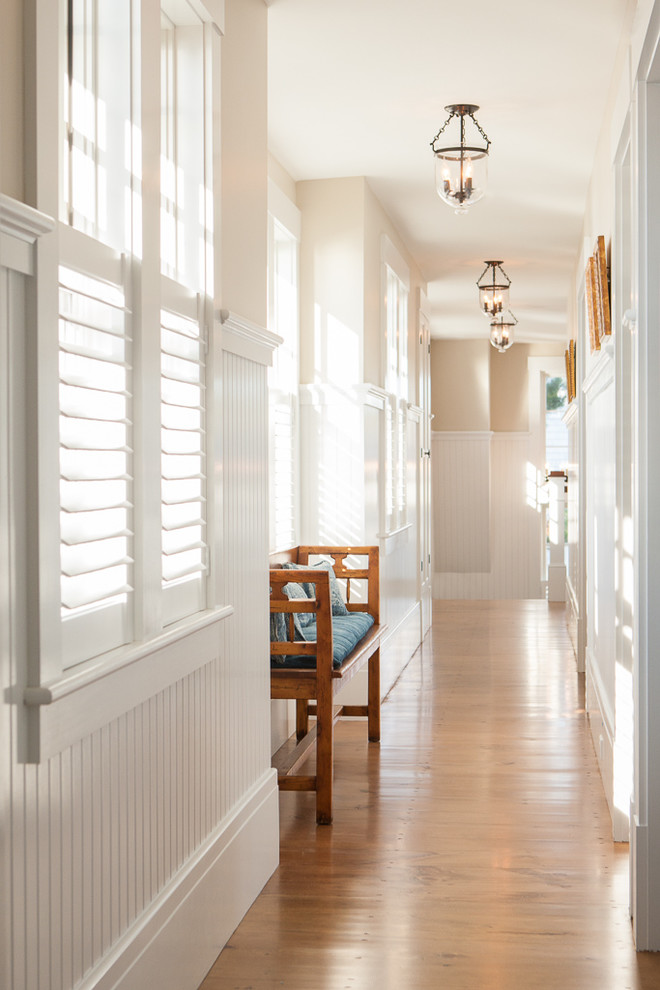 Beach style hallway in Portland Maine with beige walls and medium hardwood floors.