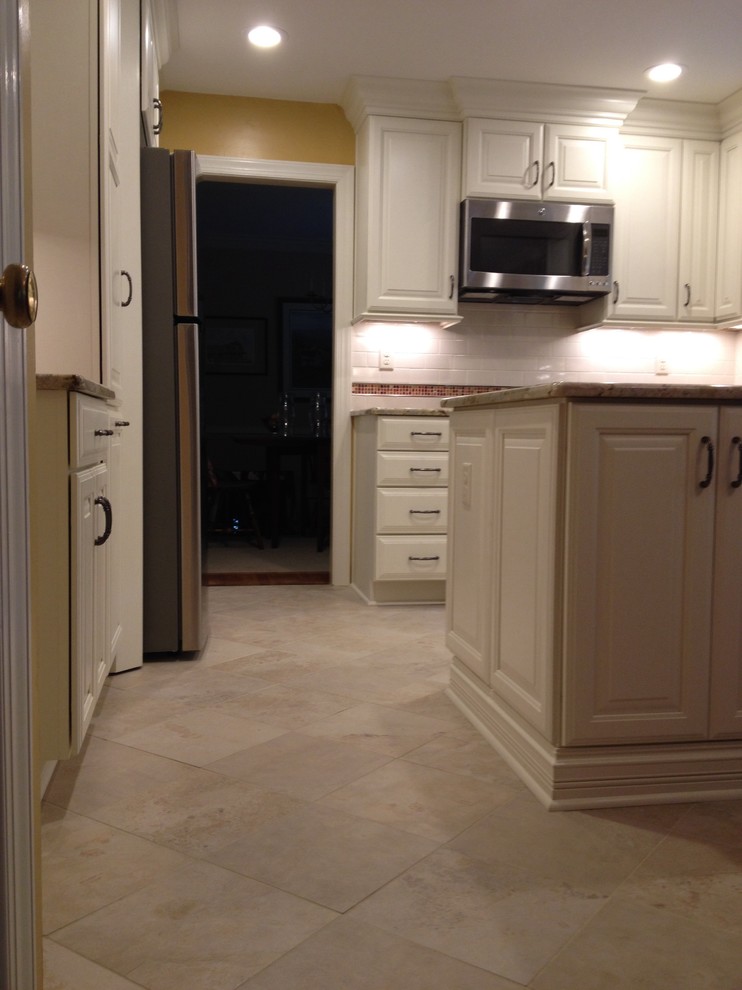 Eat-in kitchen - mid-sized transitional u-shaped ceramic tile eat-in kitchen idea in Richmond with an undermount sink, raised-panel cabinets, white cabinets, granite countertops, white backsplash, subway tile backsplash, stainless steel appliances and a peninsula