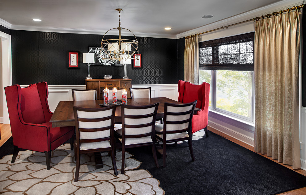 This is an example of a large transitional separate dining room in Chicago with black walls, dark hardwood floors and no fireplace.